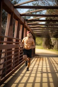 Online dating profile photoshoot client running on lady bird lake boardwalk Austin